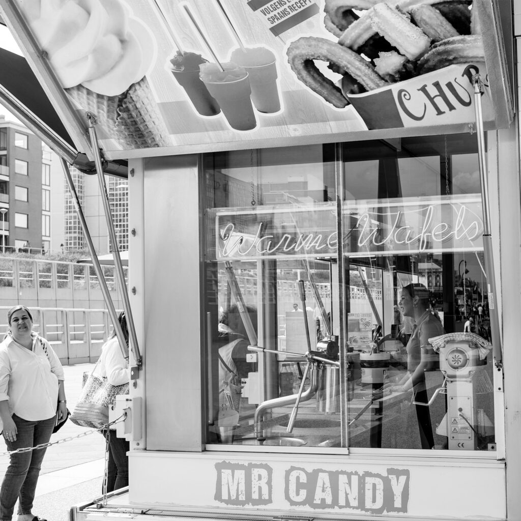 Ice cream vendor standing outside Mr Candy ice cream parlour Strandweg Noorderstrand Scheveningen