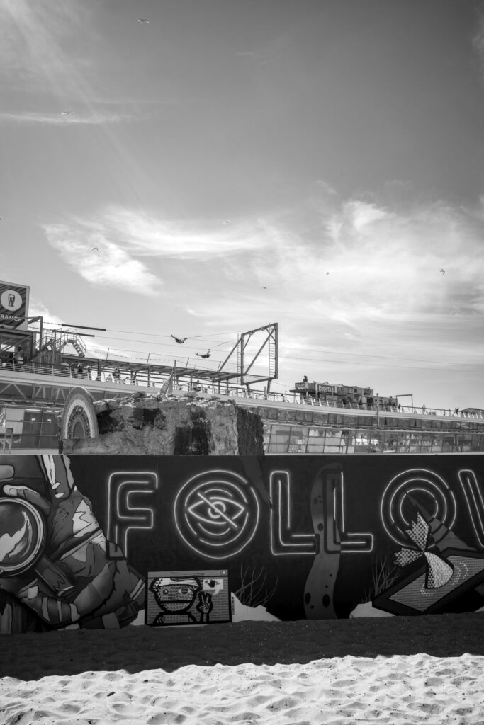 Two people hanging from zipline at Zip Line above De Pier Scheveningen