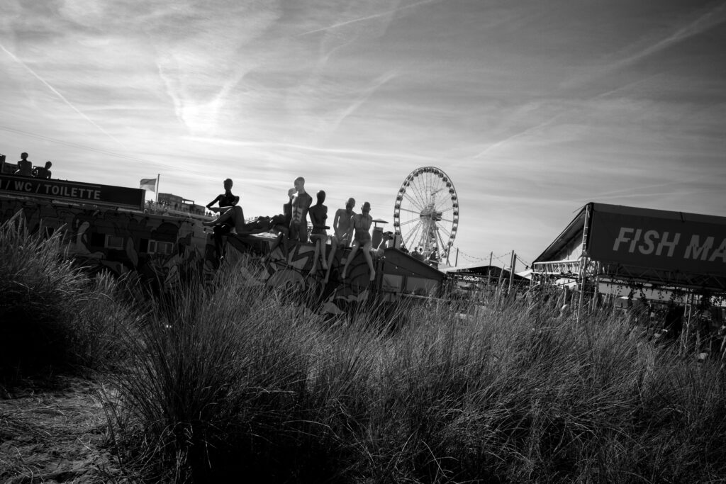 Decorative dolls displayed outside Beachclub Zeezicht near Scheveningen Pier