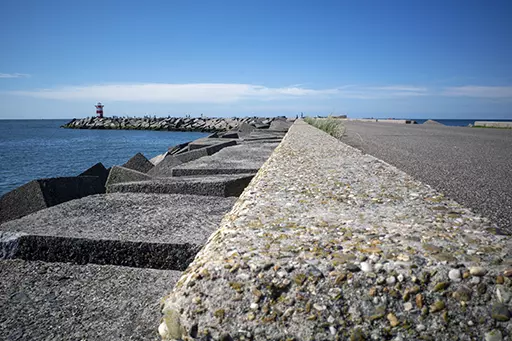 Concrete breakwater leading toward lighthouse at Noordelijk Havenhoofd Scheveningen