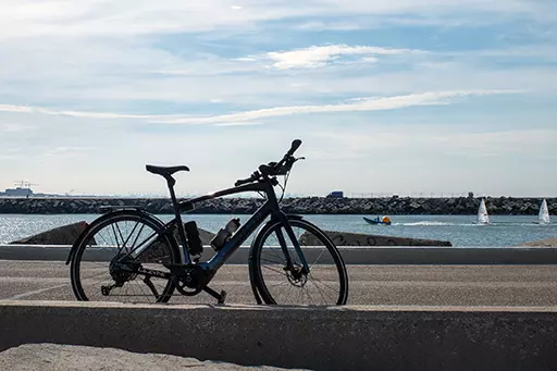 Bicycle parked on the northern harbor head of Scheveningen overlooking the sea and breakwater.